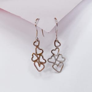 Earring with 5 open hearts dangling from an earwire.